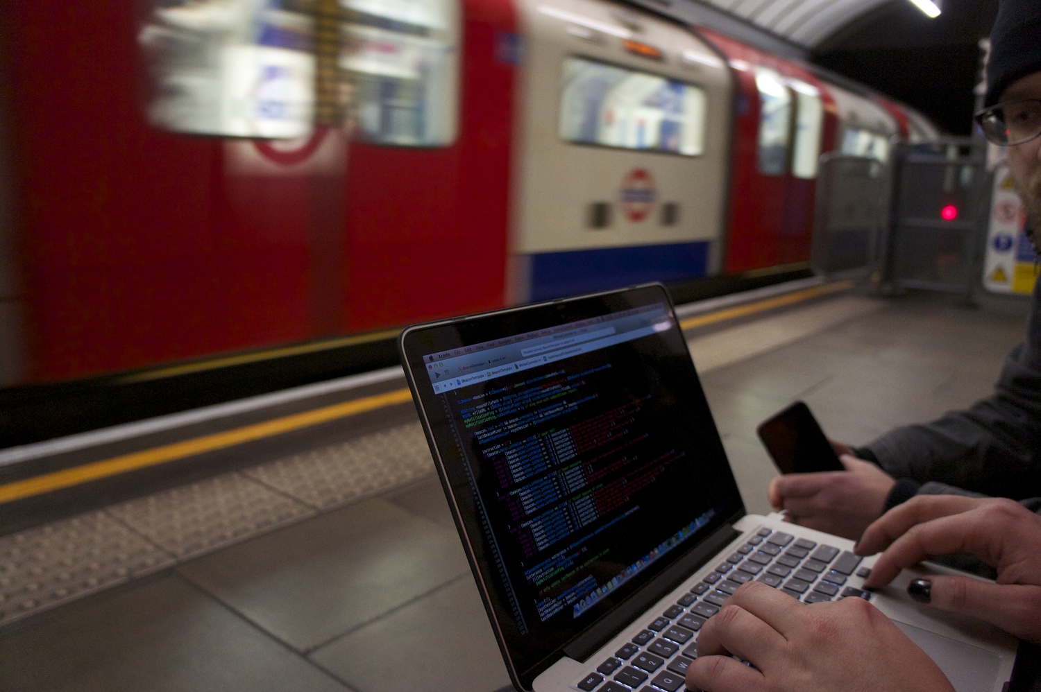 Image showing Wayfindr team coding on the tube station platform