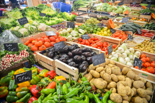 A picture with lots of vegetables separated into crates